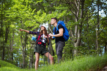 Couple with backpack enjoying at hiking trip