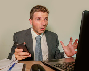 stressed and surprised businessman in suit and tie working at office laptop computer desk feeling...