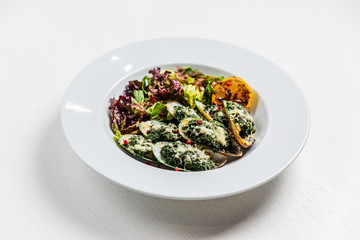 Mussels, baked with spinach and cheese, with salad and lemon