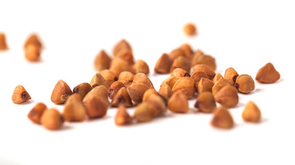 Buckwheat grain isolated on white background, healthy wood