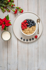 Breakfast, oatmeal with blueberry and raspberry on white bowl. Healthy food