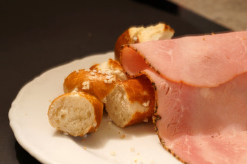 Fresh pretzel with sausage and cheese is a tasty snack
