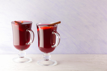 Mulled wine on white background. Christmas mulled wine, cinnamon sticks, anise and honey. Alcoholic drink of wine, fruit and honey. Festive drink and Christmas tree branches