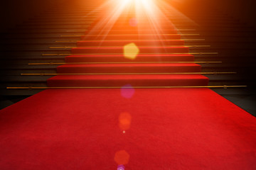 Red carpet on the stairs on a dark background. The path to glory, victory and success
