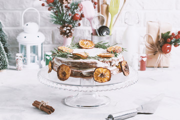 Christmas cake glass stand decorated with rosemary dried mandarin slices