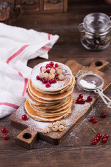 American pancakes with fresh berries on wooden background