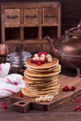 American pancakes with fresh berries on wooden background