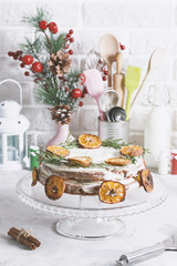 Christmas cake glass stand decorated with rosemary dried mandarin slices