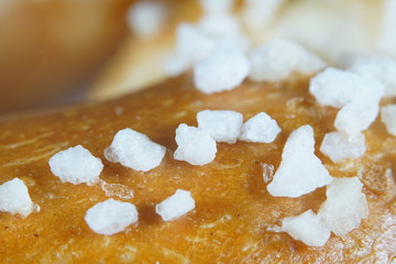 Fresh pretzel with sausage and cheese is a tasty snack