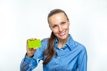 Beautiful business woman is smiling and holding a card in her hand.
