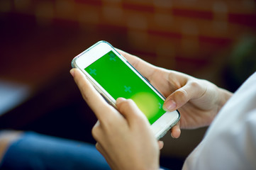 Hand and phone of the girl doing business online and business communication concept with copy space.
