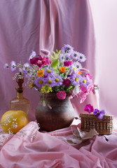 Still life with clay pot, apple and flowers