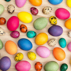  colorful easter eggs on a wooden background, top view