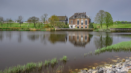 House Water Reflection With Green Landscape