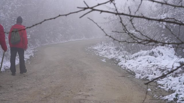Mountaineers go way through fog - (4K)