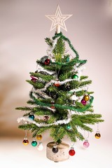 Close up view of decorative Christmas tree with small toys. Christmas Holiday Concept. Postcard. Beautiful backgrounds.