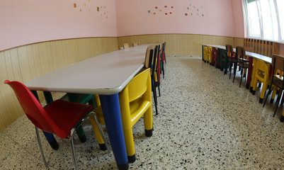 small seats and tables in a refectory