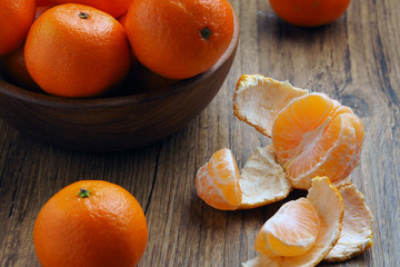 ripe tangerines on a wooden table