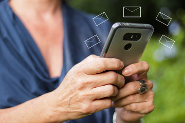 Conceptual. Adult woman send and receives messages with modern smartphone. Vector mails all around