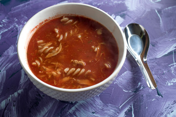 A view of a bowl of tomato soup with sour cream.