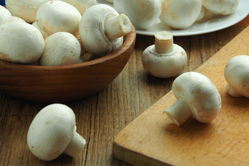 white champignons on the cutting table