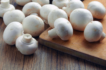 white champignons on the cutting table