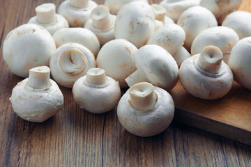 white champignons on the cutting table