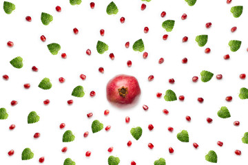 Fruit pomegranate seeds and fresh green leaf mint with water drops, scattered in a chaotic manner, isolated on white background. Food background. 