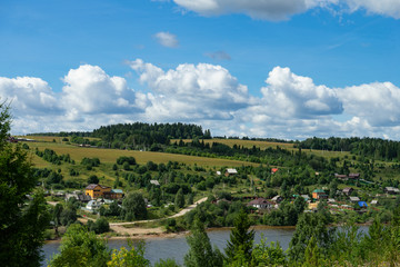 Fototapeta na wymiar Summer Landscape with River and Clouds. Country landscape.