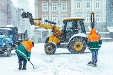 people cleaning city streets after snowstorm