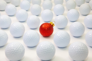 Pattern with white golf balls and red Christmas decoration