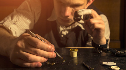 The watchmaker is repairing the mechanical watches in his workshop