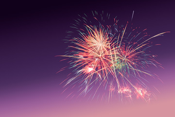 Colourful Fireworks on purple sunset twilight background with copy space to celebrate happy new year or special occasions
