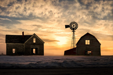 old abandoned silhoetted house and barn with beautiful sunset - obrazy, fototapety, plakaty