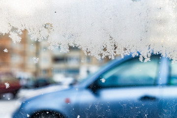 frost at window with car on background