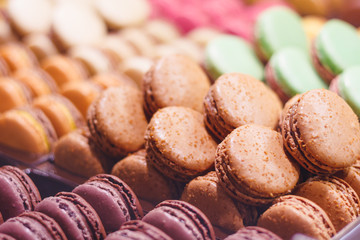 Various delicious macarons on a showcase in a French shop.