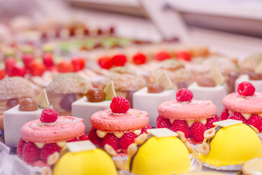 Beautiful delicious pastries with raspberry on a showcase in a French shop.