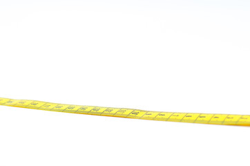 Section of yellow measuring tape on white background