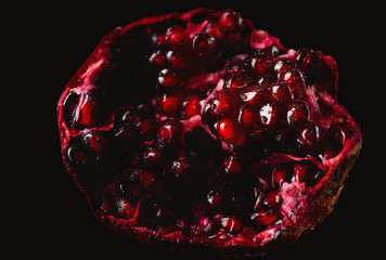 Delicious, juicy, ripe pomegranate in drops and splashes of water