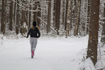 Girl running in the winter Park