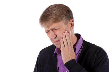 Sad depressed man in pain holding his cheek. Portrait of a man on white background. Emotion facial expression. Feelings and people reaction. Toothache