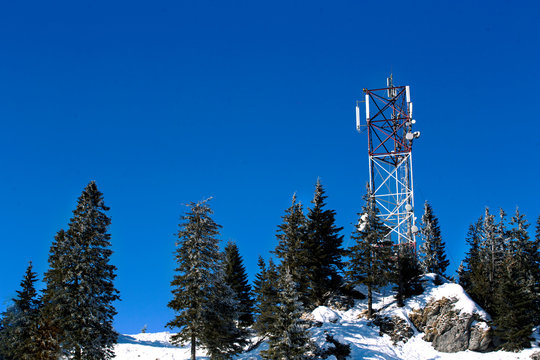 Winter fairy tale in taiga  with Radio and Bell Transmission Towers Scenic wonderland fresh snow woodland, ski arctic resort.  Europe Alps . Happy New Year! art greeting wallpaper background  