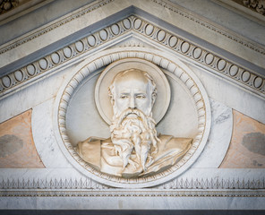 Bas relief of Saint Paul head over the main gate of the Basilica of Saint Paul Outside the Walls. Rome, Italy.