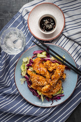 Salad with warm glazing chicken, sprinkled with sesame seeds. Chinese cuisine. Asian culture
