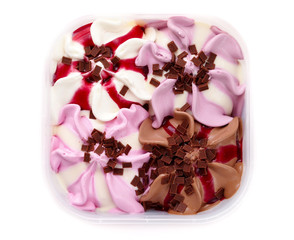 Fruit and chocolate ice cream mix in plastic bowl. White background. Top view.