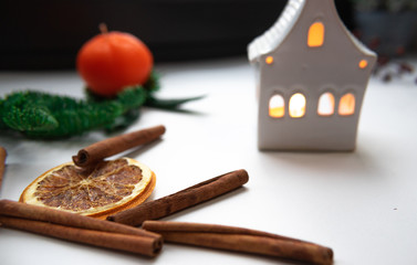 Christmas composition. Cinnamon stick, orange on white background. Flat lay, top view, copy space