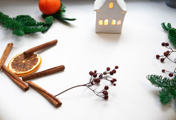Christmas composition. Cinnamon stick, orange on white background. Flat lay, top view, copy space