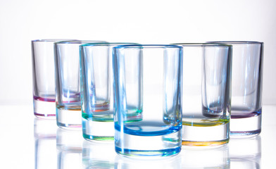 Six small colorful glasses on a white background