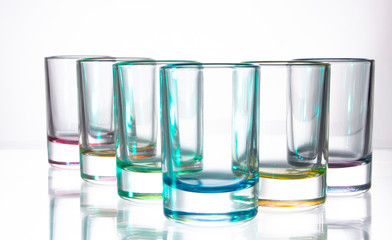 Six small colorful glasses on a white background