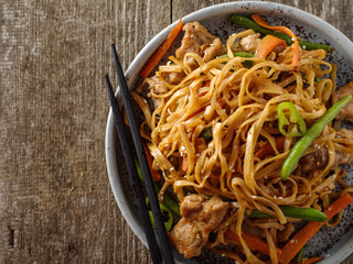 Asian noodles with pork in teriyaki sauce, with green beans, carrots and shiitake mushrooms.
